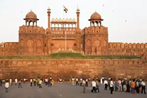 People enjoy an evening walk outside of the Red Fort (Lal Qila), built by Shah Jahan between 1638