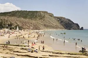 Lagos Prints: People enjoy sunshine and golden sand at the Praia da Luz beach in Lagos