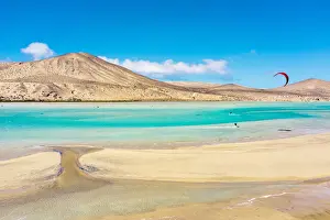 Young Man Prints: People enjoying kitesurfing at Sotavento beach (Playa de Sotavento de Jandia)
