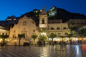 Taormina Prints: People enjoying passeggiata in Piazza IX Aprile in the hill town of Taormina at night