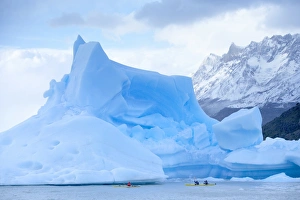 Canoeing Prints: People kayaking near floating icebergs