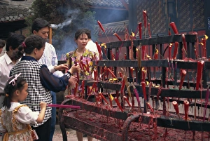 Sichuan Prints: People lighting candles in the Wenshu Temple in Chengdu, Sichuan, China, Asia