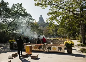 Incense Prints: People lighting incense at Po Lin Monastery with Big Buddha statue in background