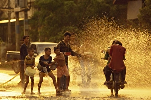 Motor Cycle Prints: People on a motorbike being showered with water by