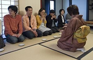 People receiving bowls of tea from the hostess at a Japanese tea ceremony, Japan, Asia