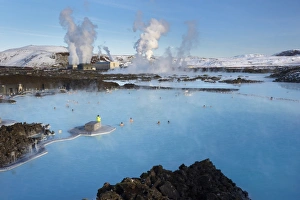 People relaxing in Blue Lagoon geothermal spa, Svartsengi Geothermal Power Station in the distance People relaxing in Blue Lagoon geothermal spa, Svartsengi Geothermal Power Station in the distance