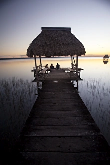 People relaxing at sunset, Lago Peten Itza, El Remate, Guatemala, Central America