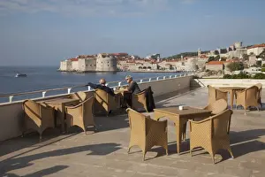 Chairs Prints: People relaxing on terrace of Excelsior Hotel with Dubrovnik Old Town in the distance