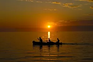Silhouetted Gallery: People rowing home at sunset at Ifaty, near Toliara, Madagascar, Indian Ocean, Africa