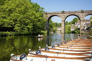 Pleasure Prints: People rowing past boats for hire in front of the Railway Viaduct over the river Nidd in Knaresborogh