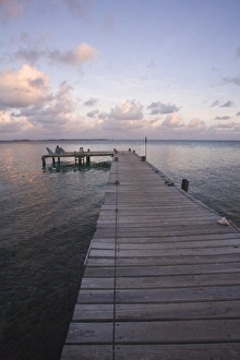 Seat Prints: People sitting on chair on jetty at sunrise, Tobaco Caye, Belize, Central America