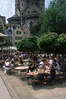 Cologne Prints: People sitting at an outdoors restaurant near St