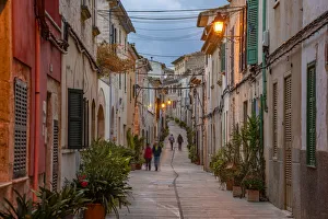 Power Line Prints: People in street in narrow street at dusk in the old town of Alcudia