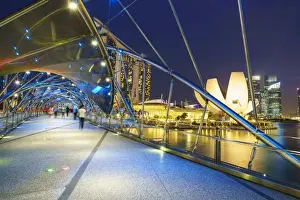 Marina Bay Prints: People strolling on the Helix Bridge towards the Marina Bay Sands and ArtScience Museum at night
