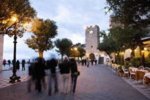People strolling in Piazza IX Aprile in the evening
