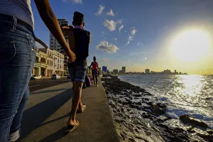Malecon Prints: People walk along the Malecon as the sun sets, Havana, Cuba, West Indies, Central America
