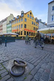 Cobbled Prints: People walk in the pedestrian roads of the entertainment district of Nyhavn, Copenhagen