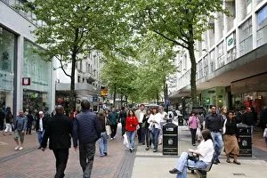 Birmingham Prints: People walking down New Street, a pedestrian street with many shops. Birmingham