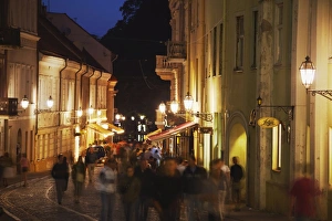 Vilnius Prints: People walking along Pilies Gatve at dusk, Vilnius, Lithuania, Baltic States, Europe