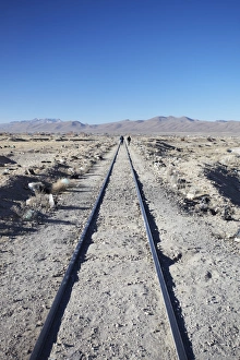 Train Track Prints: People walking along train tracks, Uyuni, Potosi Department, Bolivia, South America