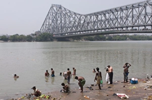 Images Dated 5th April 2009: People washing in the River, Howrah Bridge in background, Kolkata, West Bengal