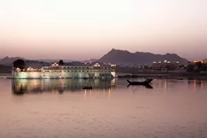 Perfect reflection of Lake Palace Hotel at dusk, situated in the middle of Lake Pichola