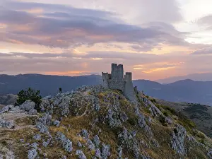 Autumnal Prints: A person admires the Rocca Calascio castle during an autumn sunrise