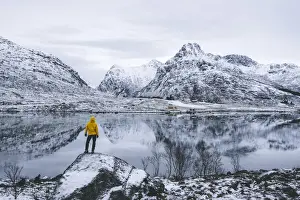 40 44 Years Prints: Person admiring the snowcapped mountains reflected in frozen sea