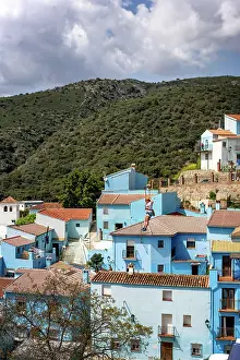 House Exterior Prints: Person doing slide (zip line) in blue painted Smurf village of Juzcar