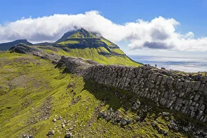 Mid Adults Prints: One person hikes the ridge toward the Skaelingsfjall mountain