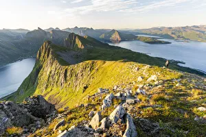 40 44 Years Prints: Person hiking on Husfjellet mountain at dawn, Senja island, Troms county, Norway