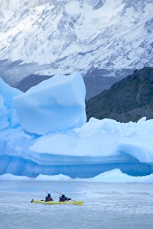 Person kayaking near floating icebergs, Lago Gray (Lake Gray), Torres del Paine National Park