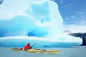 One Man Only Prints: Person kayaking near floating icebergs