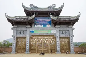 Motorbike Prints: A person looking up at Bai Dinh Temple (Chua Bai Dinh) gate