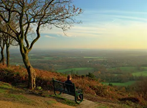 Person looking across the Weald with a view for 25 miles to the South Downs from the Greensand Ridge, Pitch Hill, Ewhurst, Surrey, England, United Person looking across the Weald with a view for 25 miles to the South Downs from the Greensand Ridge, Pitch Hill, Ewhurst, Surrey, England, United