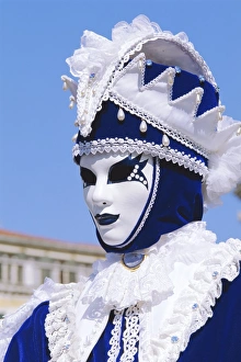 Person wearing masked carnival costume