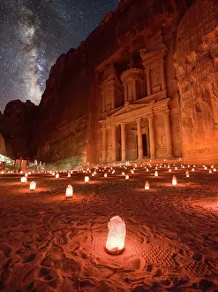 Treasury Prints: Petra Treasury (El Khazneh) by night illuminated by small lanterns and the Milky Way in the sky