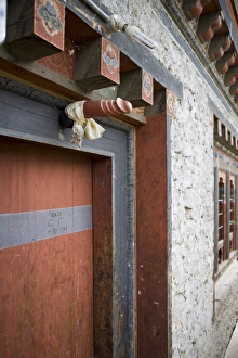 Bhutan Prints: Phallus above house door to ward off evil spirits, Jankar, Bumthang Valley, Bhutan, Asia