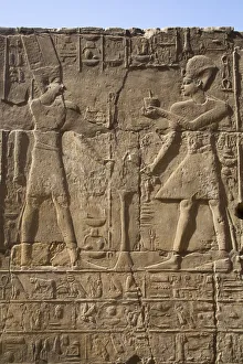 Pharaoh on right, God Amun on the left, Bas Relief, Luxor Temple