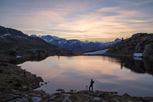 Photographer Prints: Photographer admires the pink sunrise on Lake Zana