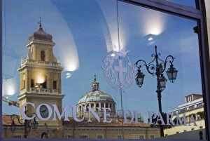 Piazza Garibaldi reflected in the glass of the Town Hall, Parma, Emilia Romagna