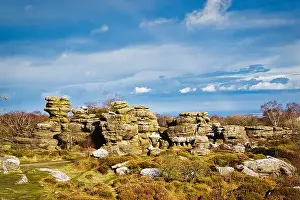 Picturesque rocky landscape with unique rock formations under a blue sky with fluffy clouds at Brimham Rocks, in North Yorkshire