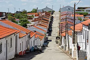 Alentejo Prints: Picturesque street lined with white houses and red roofs in a village of Beja