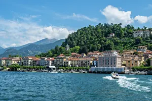 Attractions Prints: Picturesque view of Bellagio along Lake Como with boats and hills under clear sky