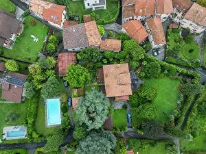 Homes Prints: Picturesque view of homes and greenery near Lake Como in Italy during a sunny day