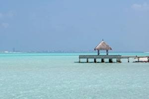 Azure Prints: Pier and the clear waters of the lagoon on an exotic Island in The Maldives, Indian Ocean