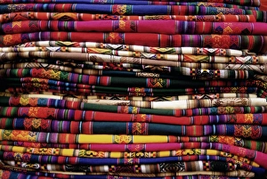 Colourful Prints: Detail of a pile of colourful ponchos