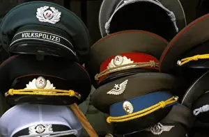 Mitte Prints: A pile of Communist era army and police hats for sale as souvenirs