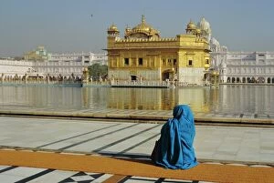Images Dated 1st August 2008: A pilgrim in blue sits by the Holy Pool of Nectar at