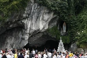 Pilgrim outside the Lourdes grotto, Lourdes, Hautes Pyrenees, France, Europe